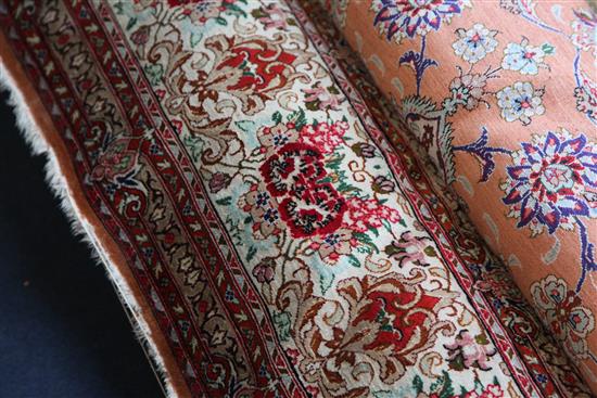 A Persian silk rug, 9ft 8in by 6ft 5in.